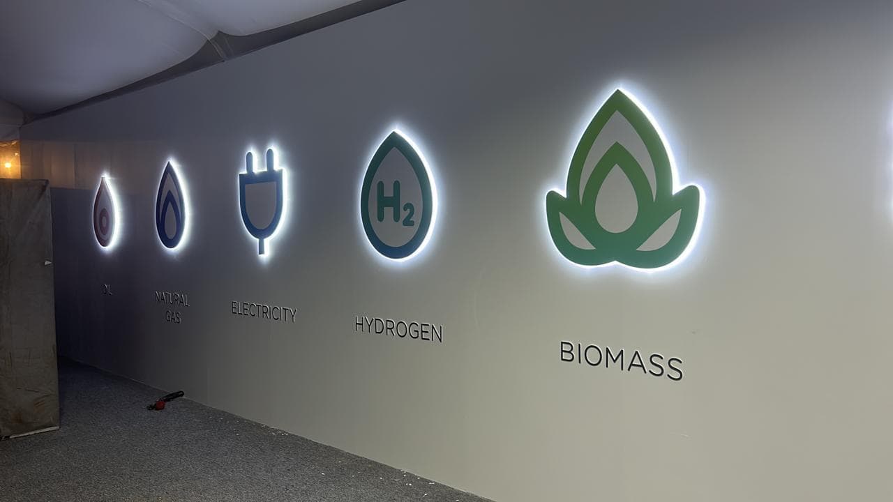 Backlit energy-transition feature wall — oil, natural gas, electricity, hydrogen and biomass icons